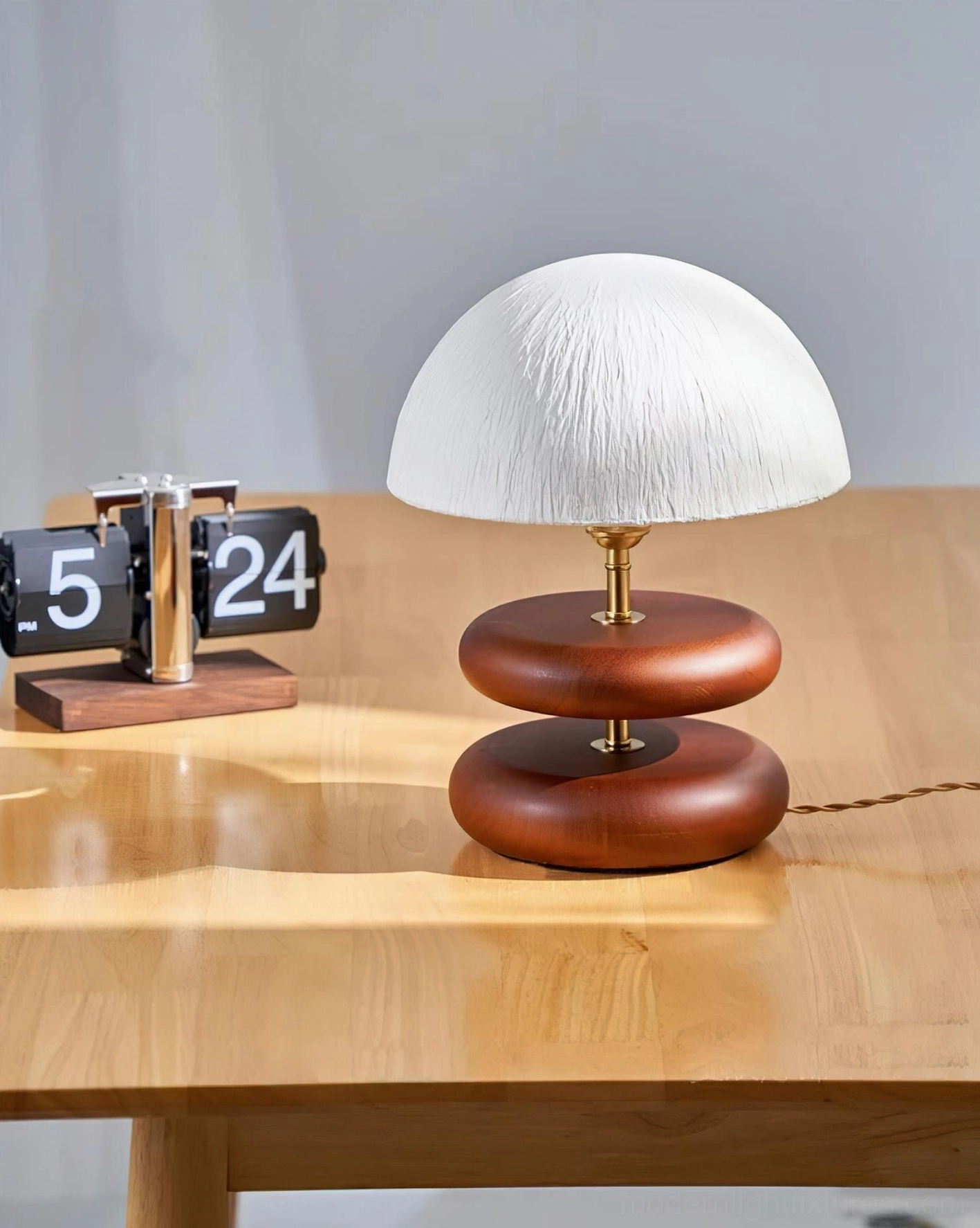 Stacked wood ring table lamp three quarter angle dark brown base brown twisted power cord contemporary