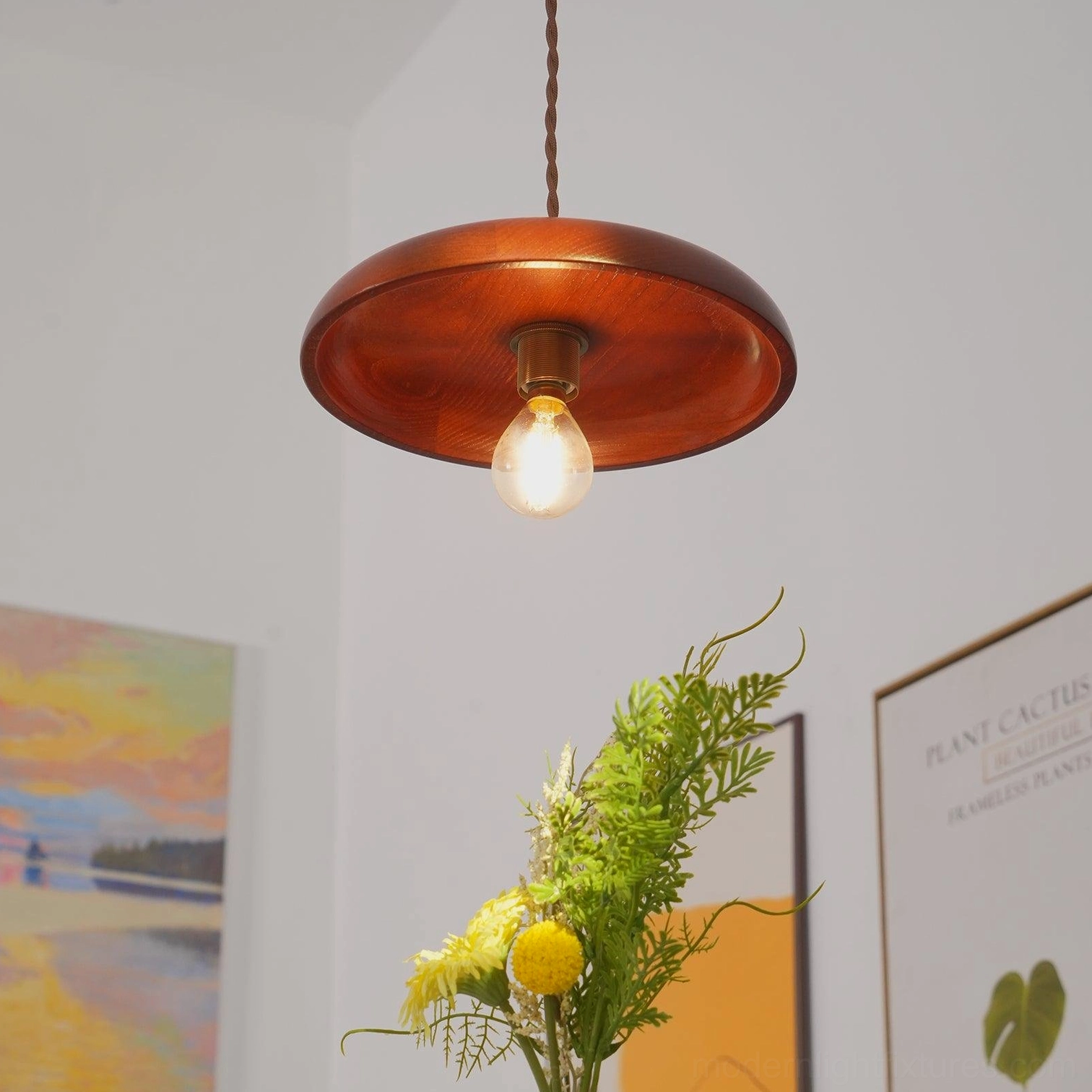 Close-up front view of smooth walnut wood shade with brass hardware and exposed Edison bulb