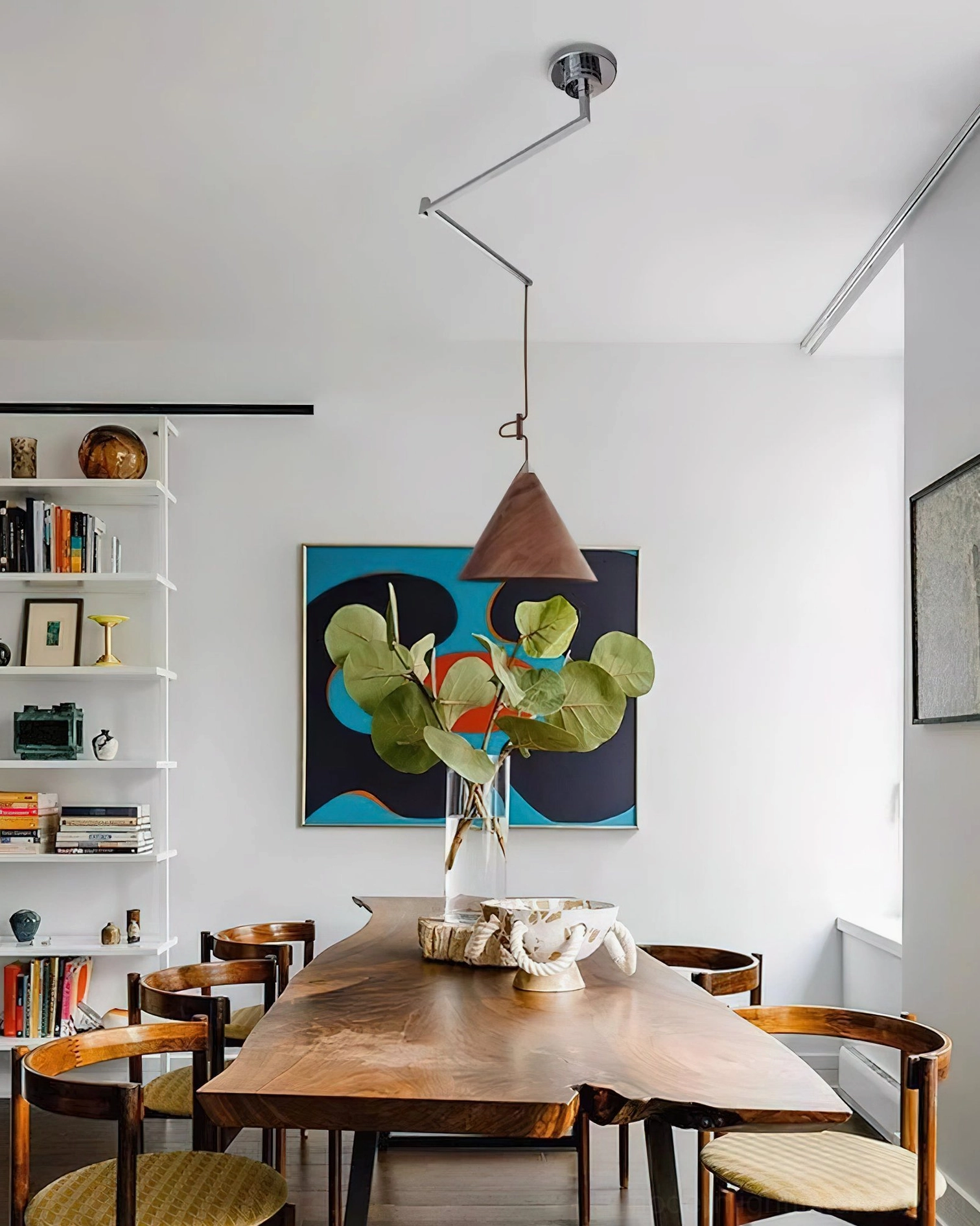 Mid-century swing arm wood pendant lamp in contemporary dining room setting