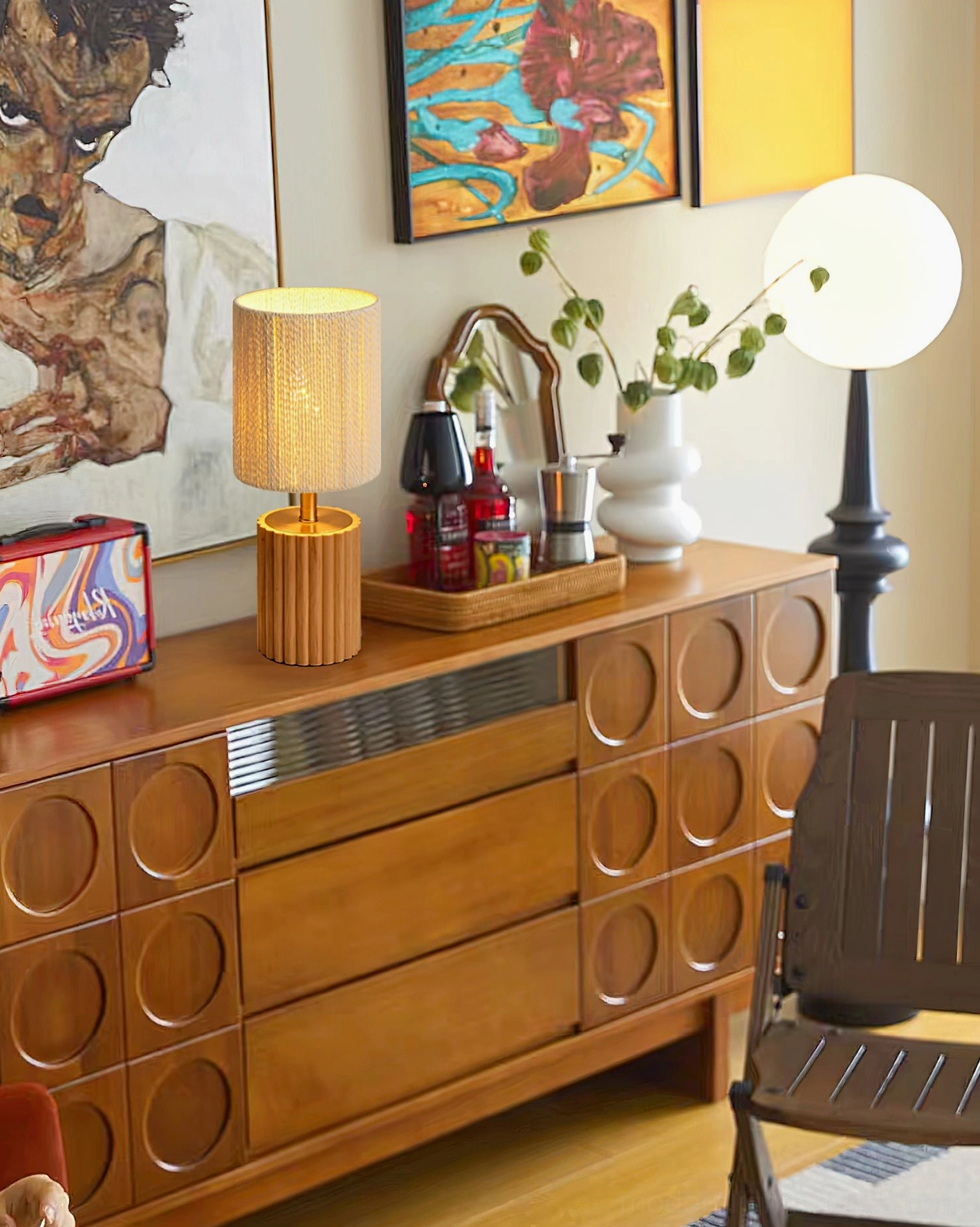 Modern grooved wood table lamp styled in vintage retro living room with sideboard and wall art decor