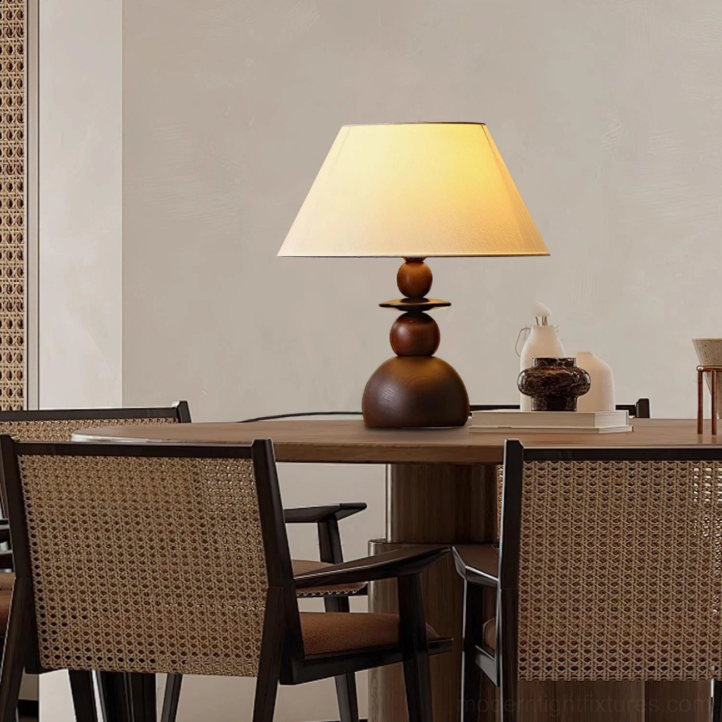 Table lamp with warm fabric shade and layered walnut wood base creating dimensional visual design