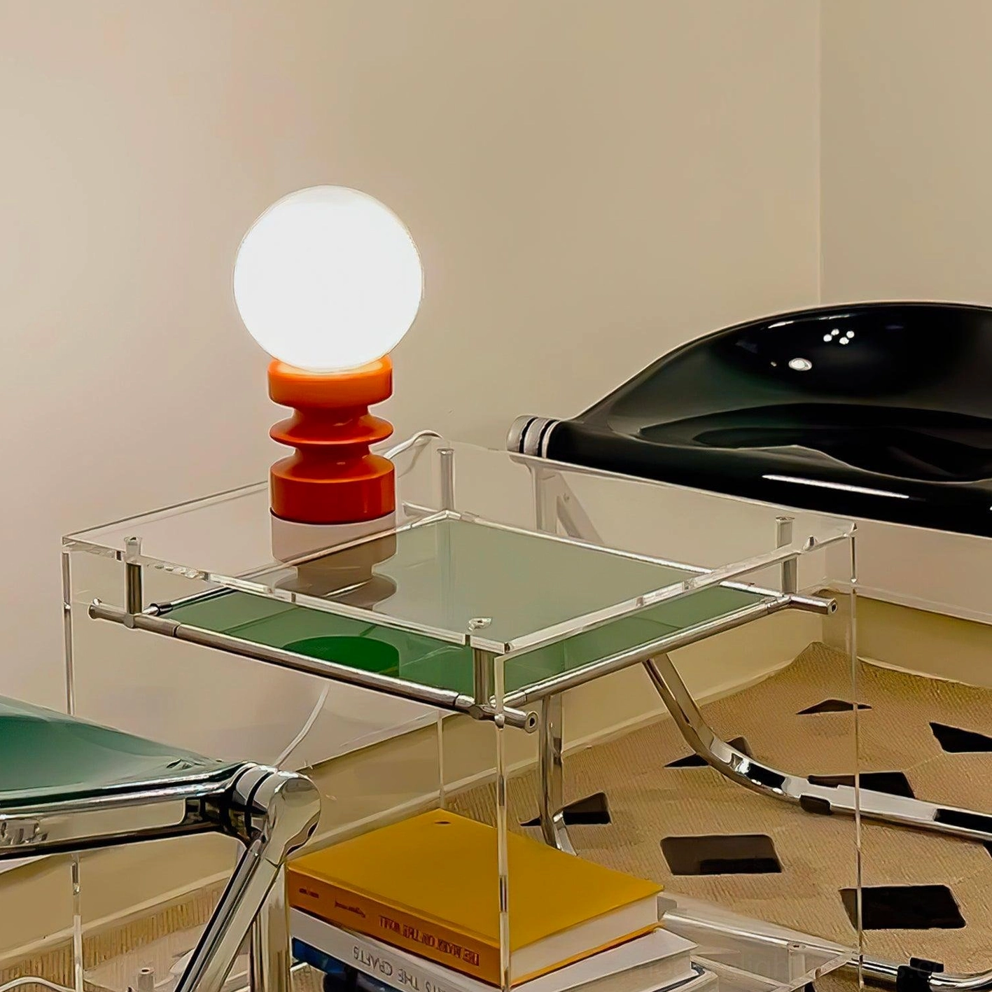Illuminated wood and glass table lamp on contemporary acrylic side table with books
