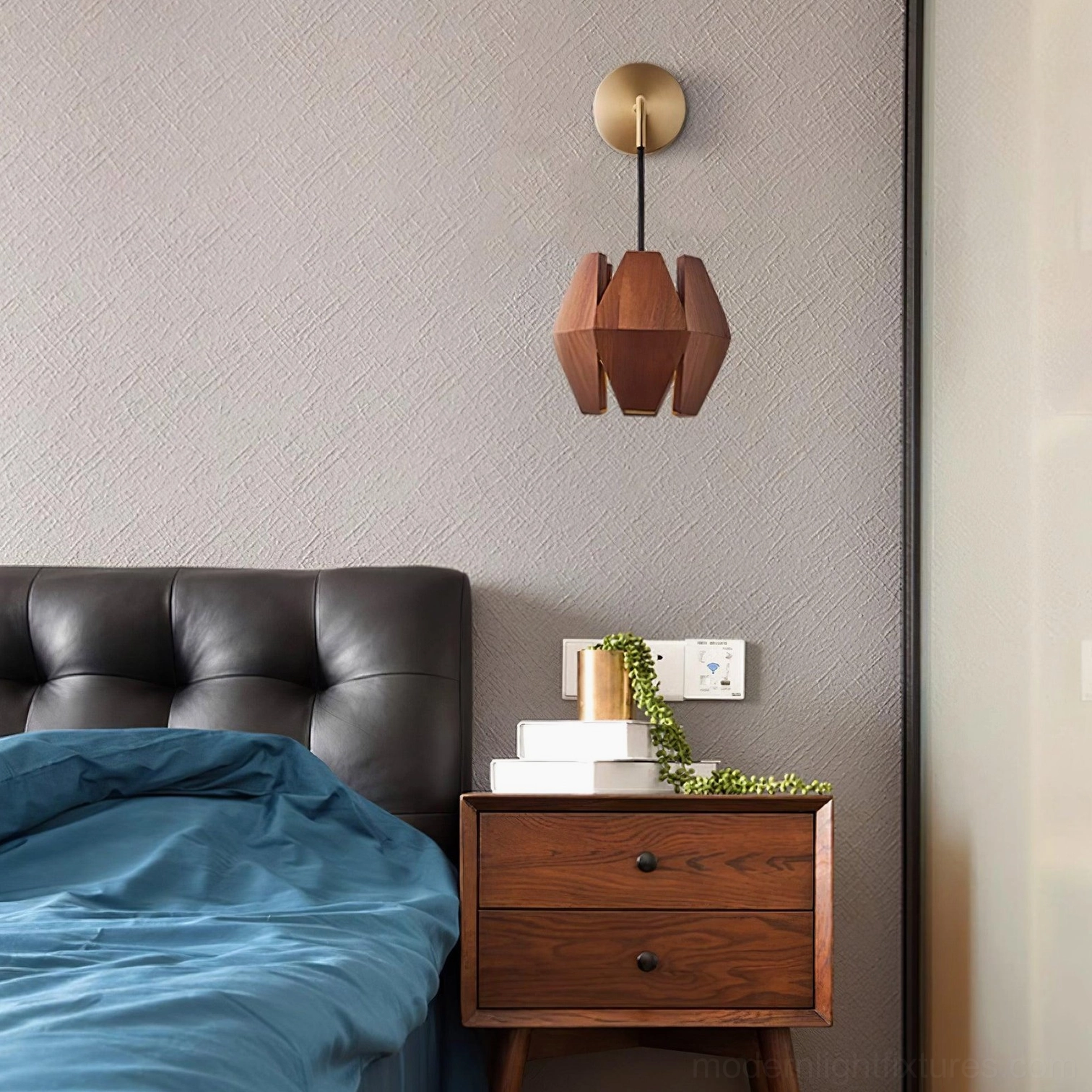 Modern faceted wood sconce mounted above dark wood nightstand with tufted headboard