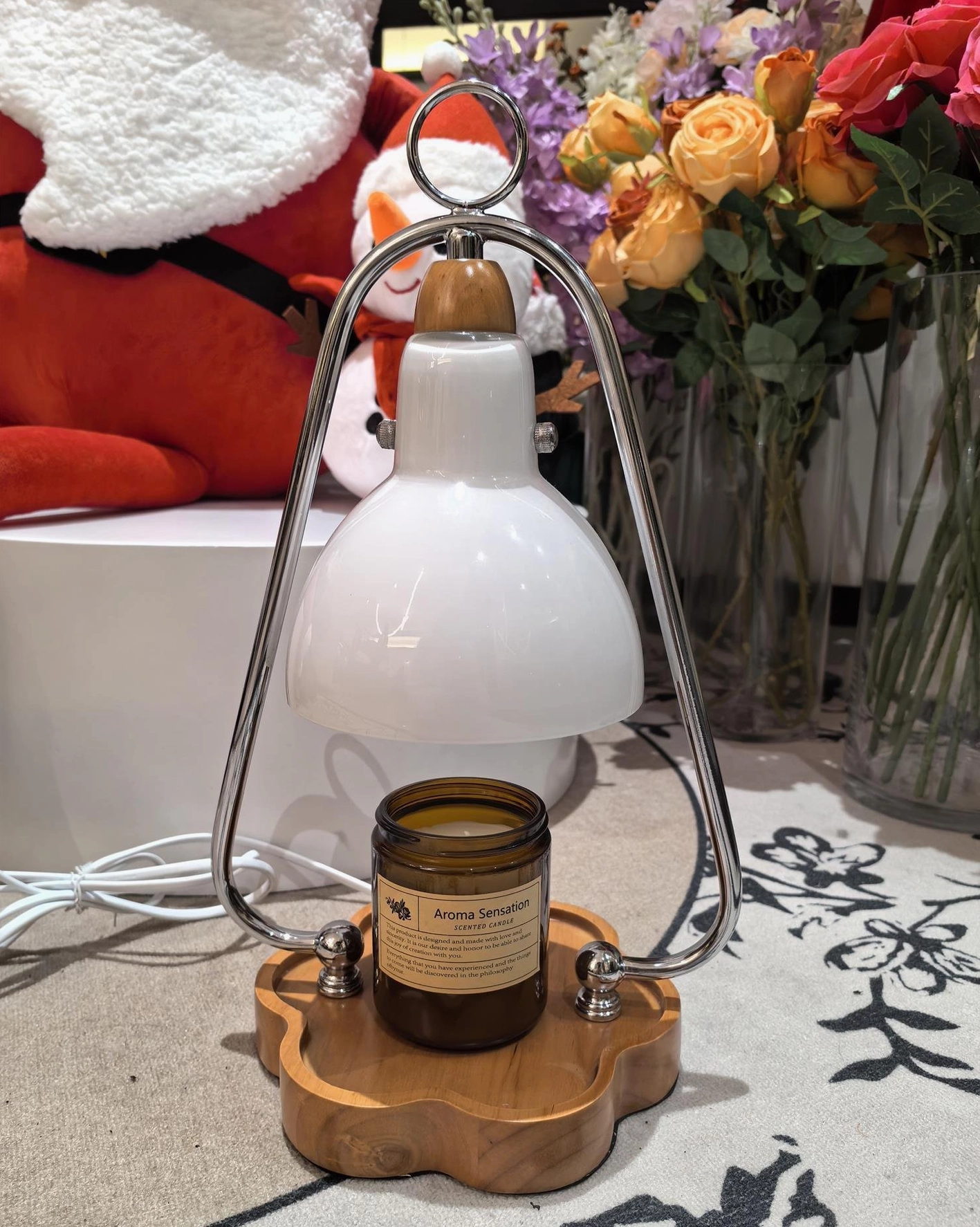 Unlit candle warmer table lamp with natural wood base among home decorative accessories