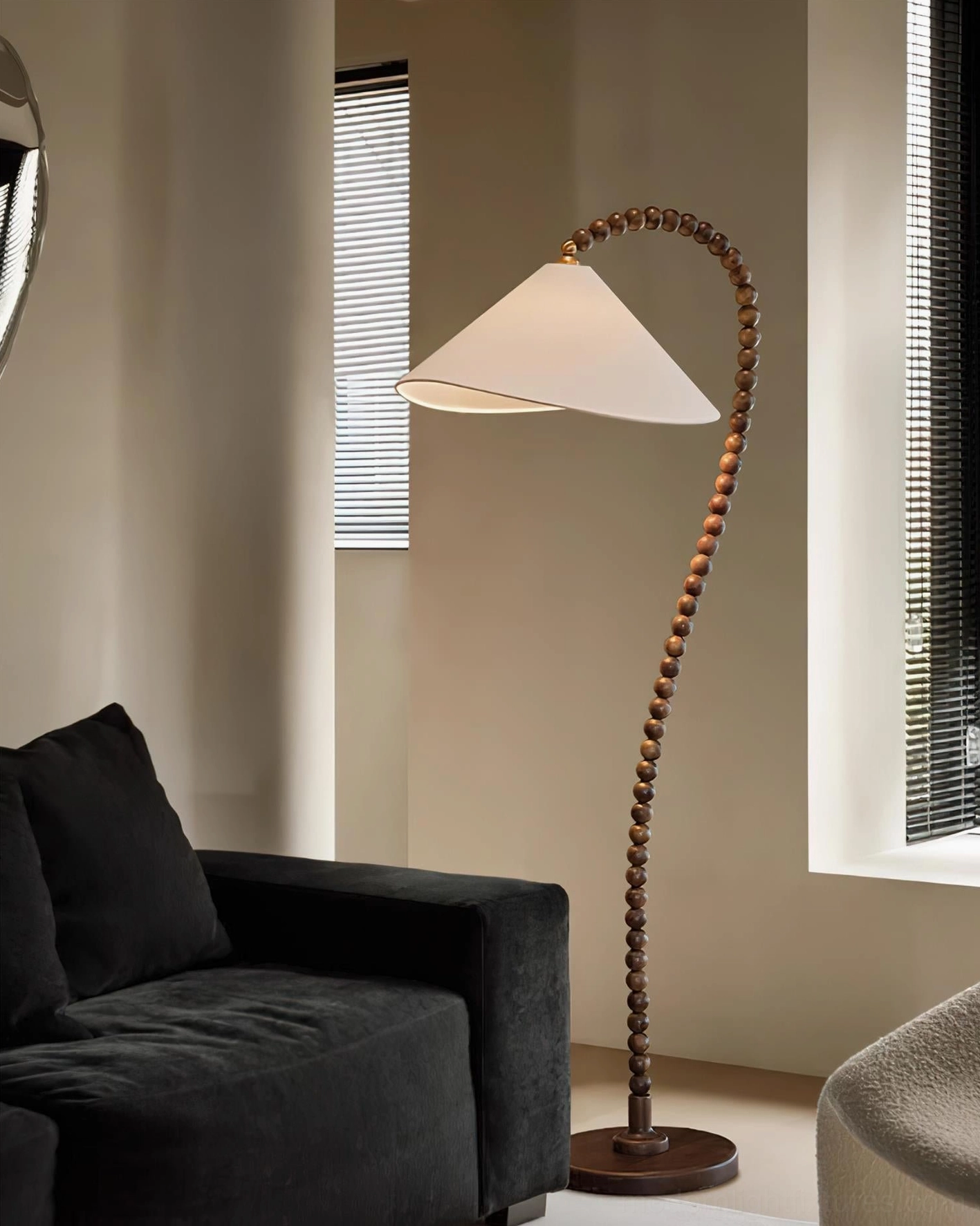 Walnut beaded floor lamp providing warm ambient lighting in home reading space