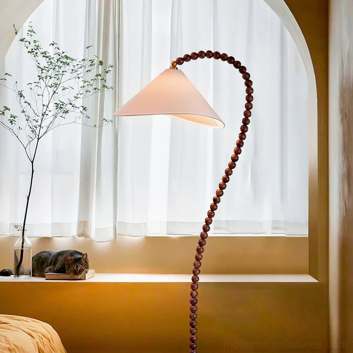 Arched wooden bead floor lamp in bedroom window nook with sheer curtains and yellow bench