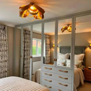 Modern semi-flush wood light fixture installed in master bedroom overhead view