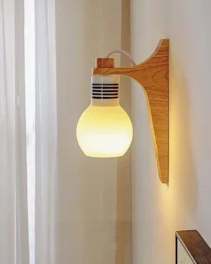 Wooden wall sconce with lit warm globe, bedside lighting application, soft ambient illumination in bedroom setting