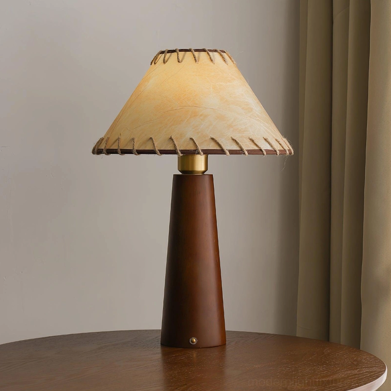 Wooden table lamp base detail showing grain texture and solid construction quality with hand-stitched fabric shade