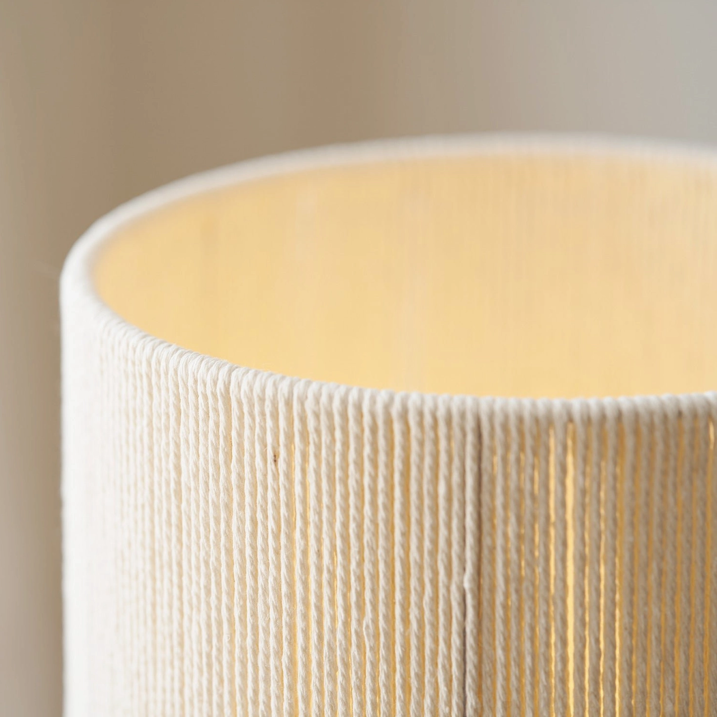 Wooden lamp with natural wood grain showing warm light through beige fabric shade