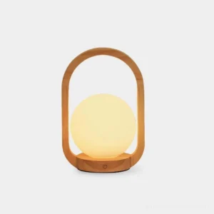 Front studio view of wooden portable table lamp with frosted globe shade and natural wood frame on white background
