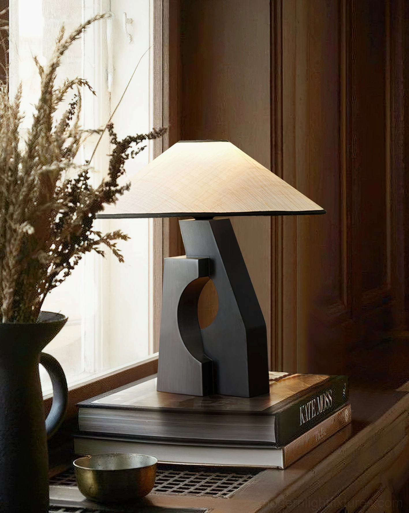 Wabi-sabi minimalist wood table lamp with dried florals and stacked books on wooden dresser