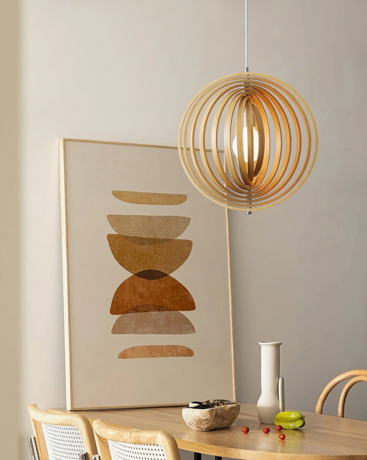 Side eye-level view of wooden sphere pendant lamp in modern dining corner with warm ambient lighting