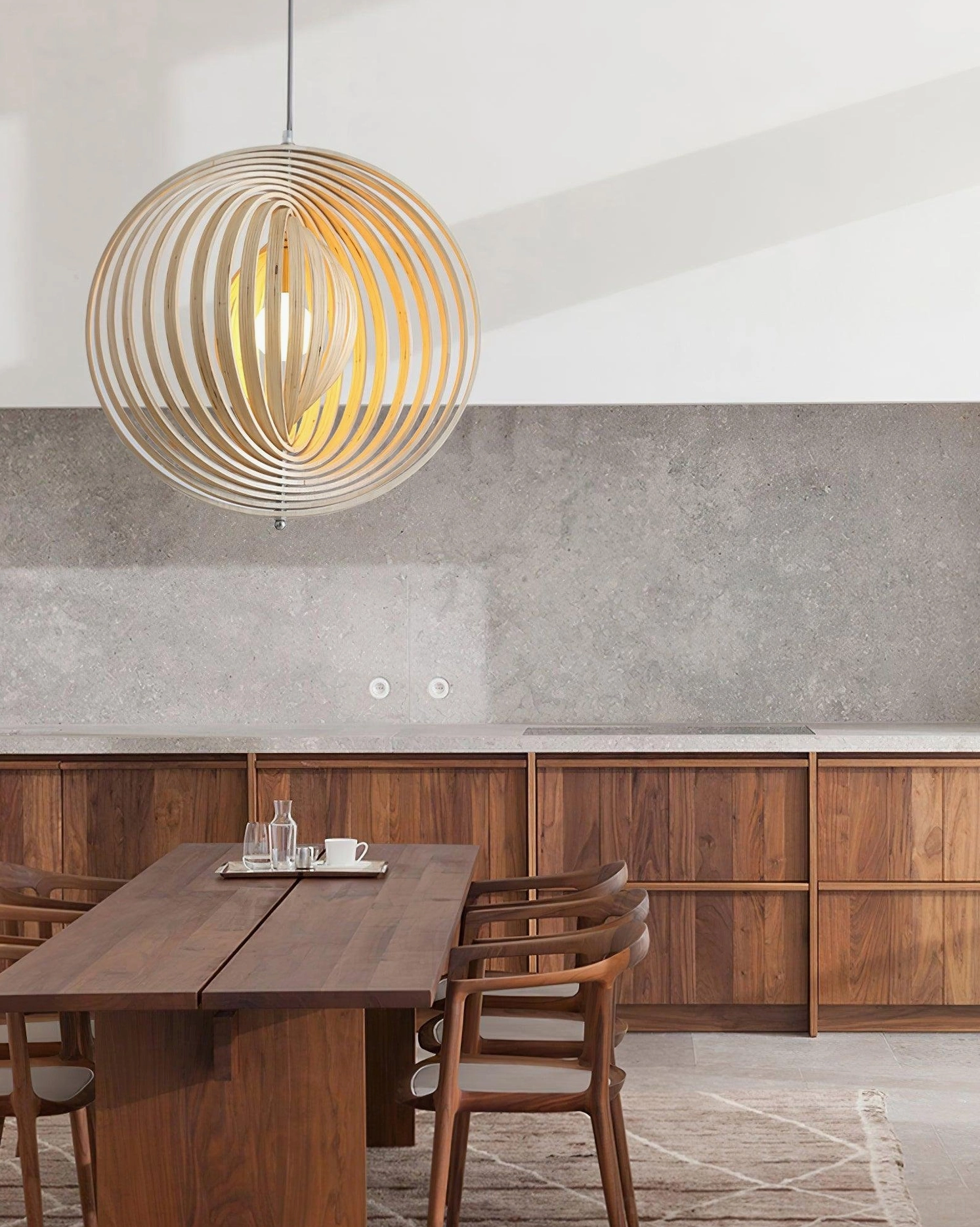 Overhead view of wooden sphere pendant light in modern dining kitchen space casting warm ambient lighting