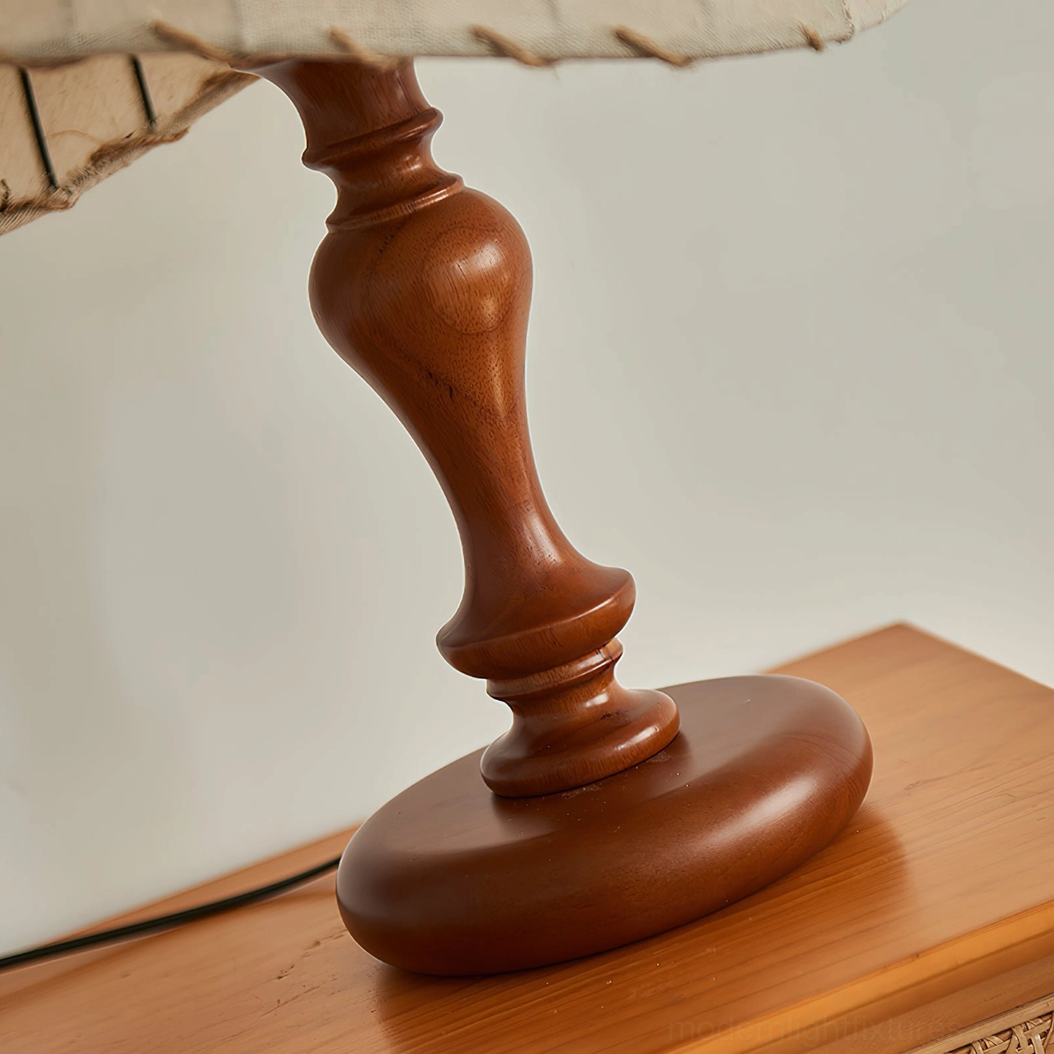 Solid wood turned spindle base with power cord visible, polished walnut finish detail