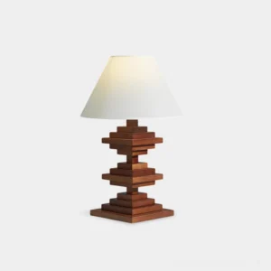 Geometric wooden tower table lamp with stacked wood base and neutral fabric shade in walnut finish, studio front view on white background