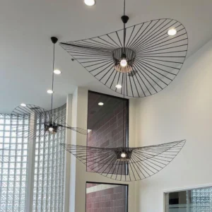 Multiple woven fiber glass pendants hung at varying heights in modern minimalist duplex apartment hallway