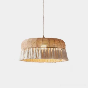 Handwoven natural hemp rattan tassel pendant light with drum shade and white fringe trim, front studio view