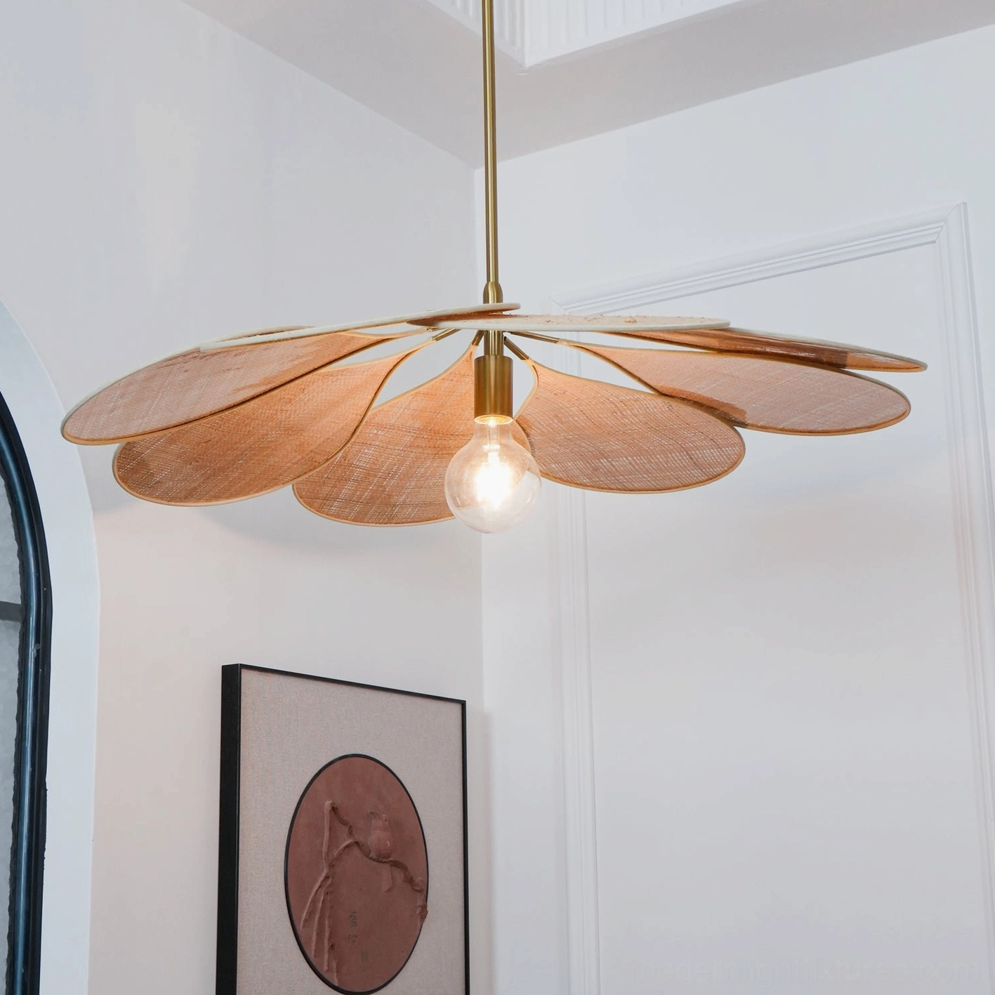 Woven rattan bloom pendant with warm ambient light in contemporary home setting
