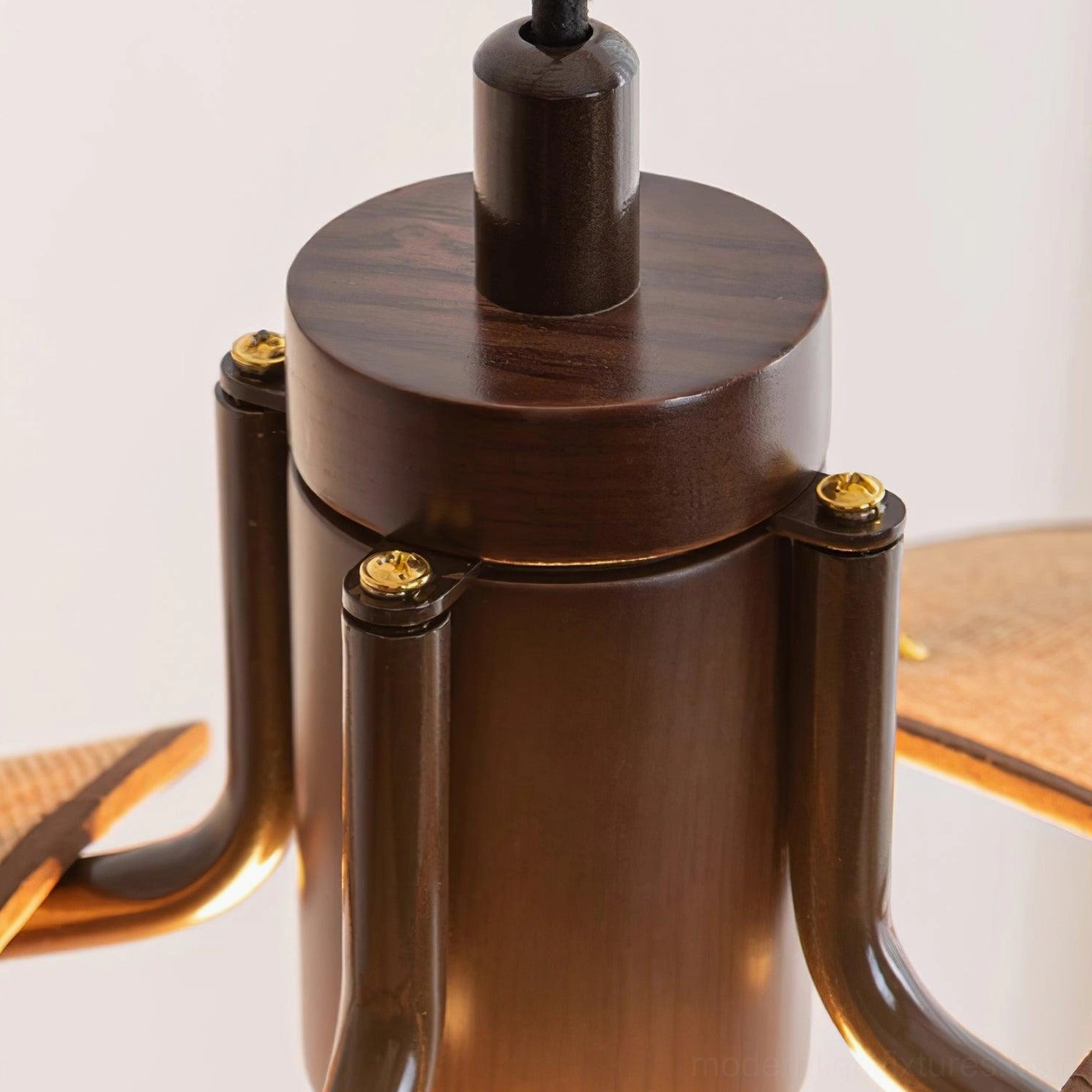Woven rattan flower pendant with dark brown metal fixture in contemporary home décor environment