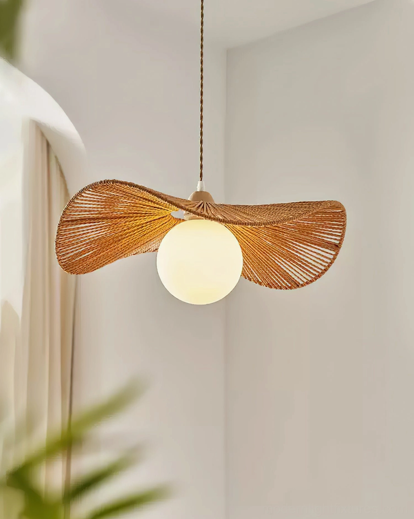 Woven rattan pendant light fixture with natural brown shade and white spherical bulb detail
