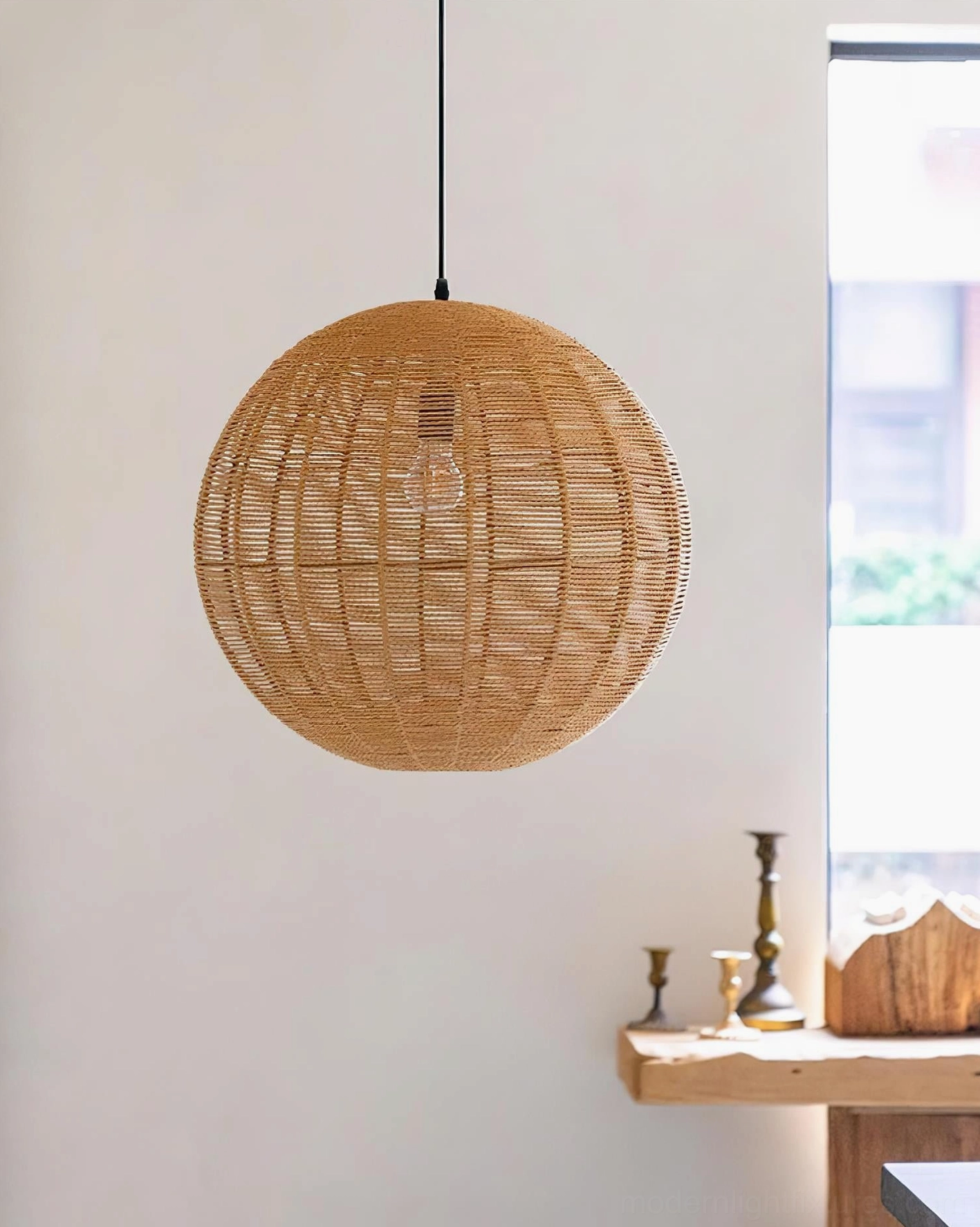 Close-up overhead view of woven rattan pendant light above side table with wooden accents