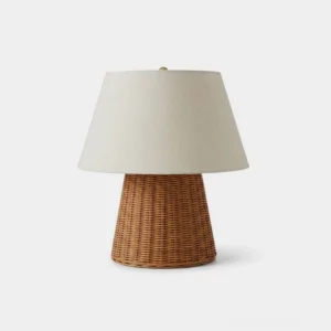 Briora woven rattan table lamp with cream linen shade on white background, front view - hand-woven tapered rattan base and fabric empire shade
