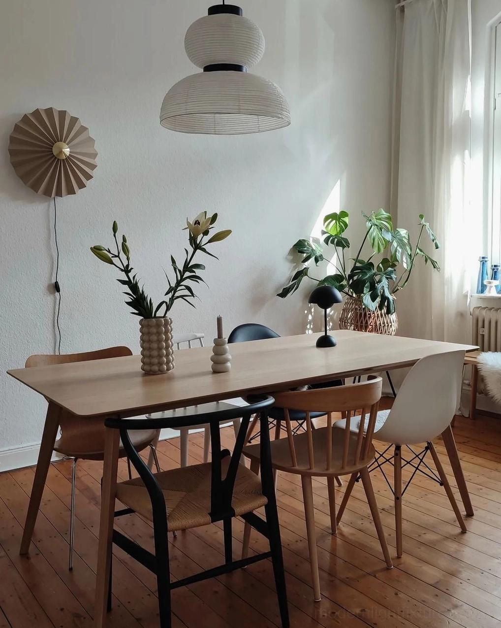 Xuan paper pendant lamp suspended in contemporary residential interior with natural light
