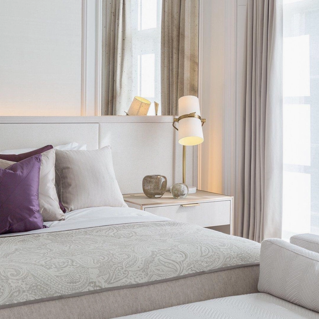 Yasmin rotating table lamp in modern bedroom setting with rotating shade feature