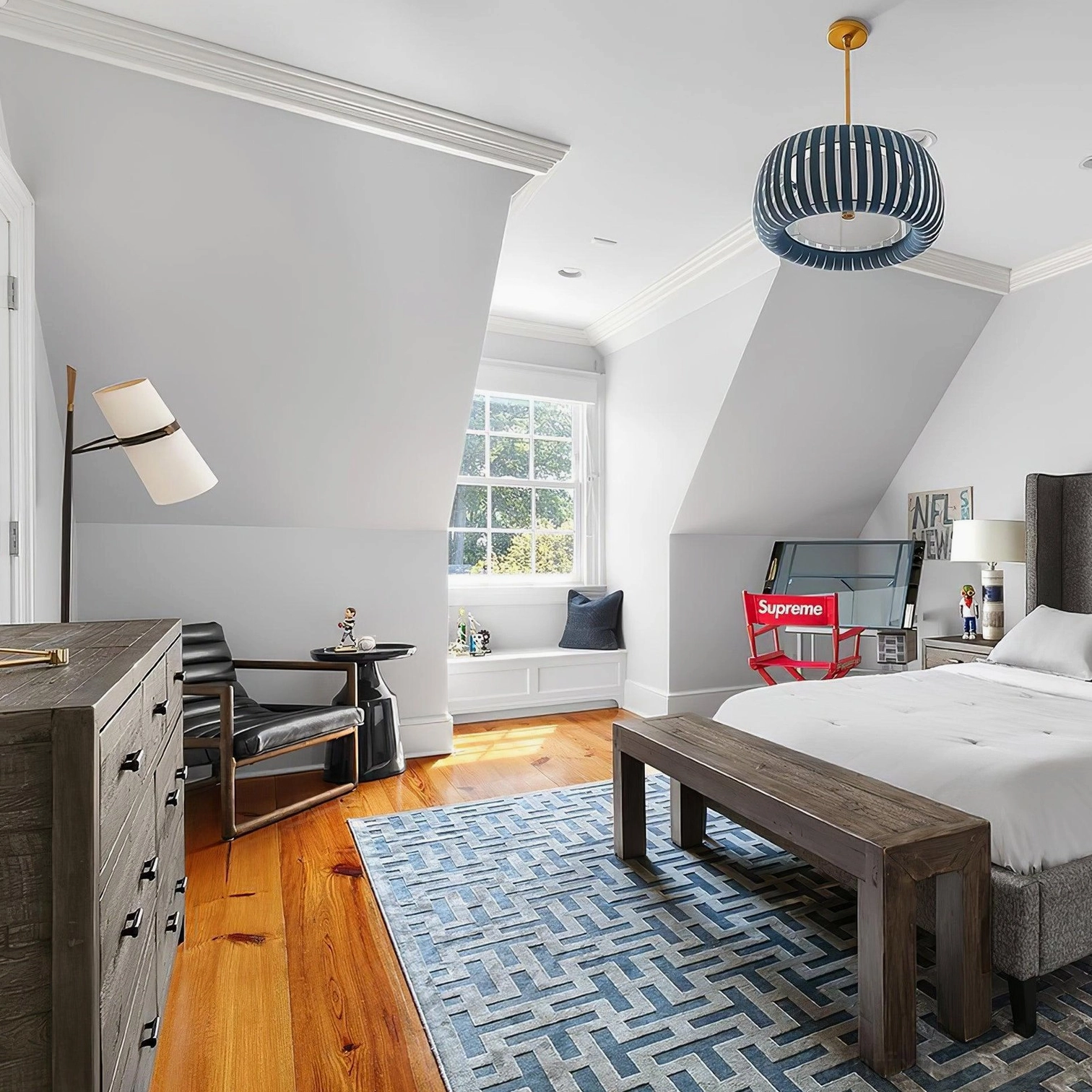 Yasmin table lamp in minimalist attic bedroom with geometric area rug