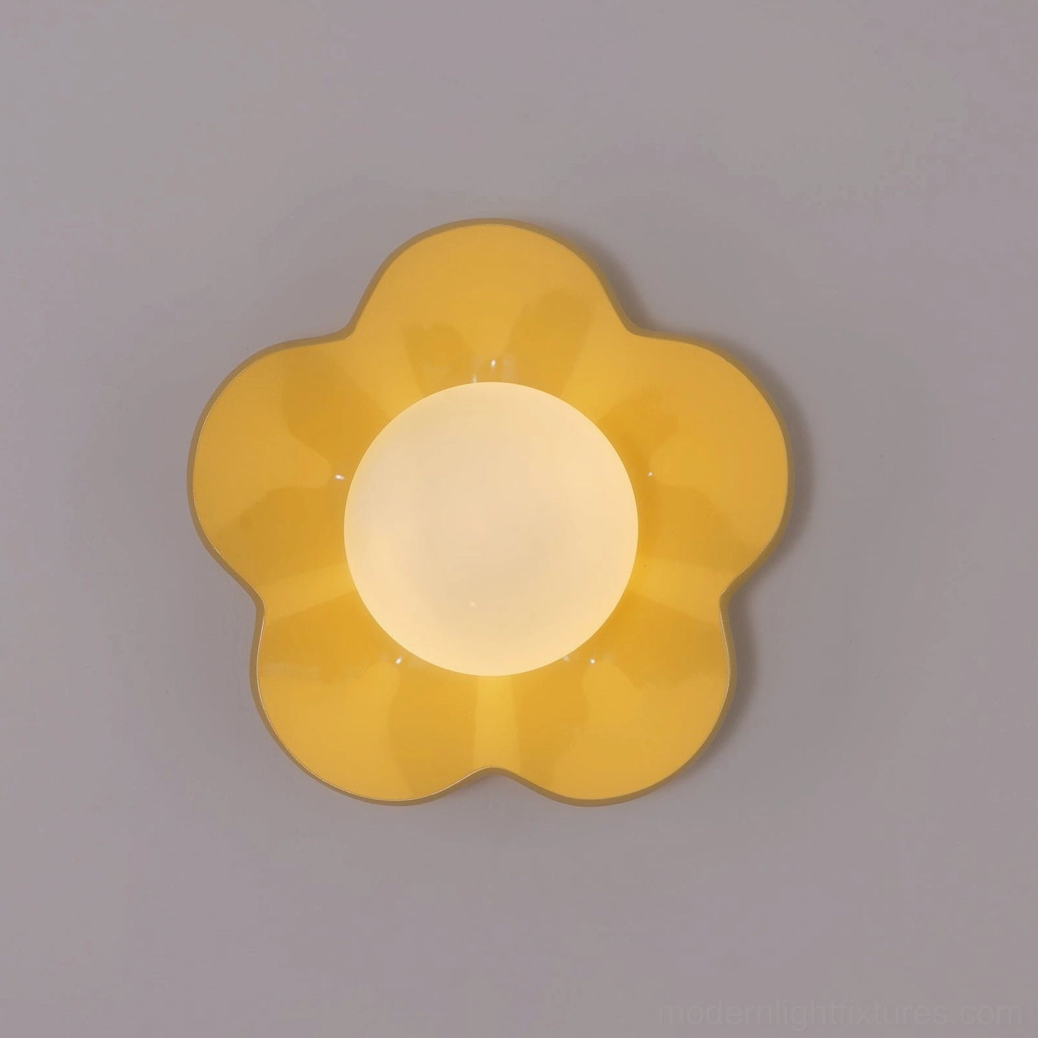 Illuminated yellow flower wall lamp with frosted glass shade casting soft light