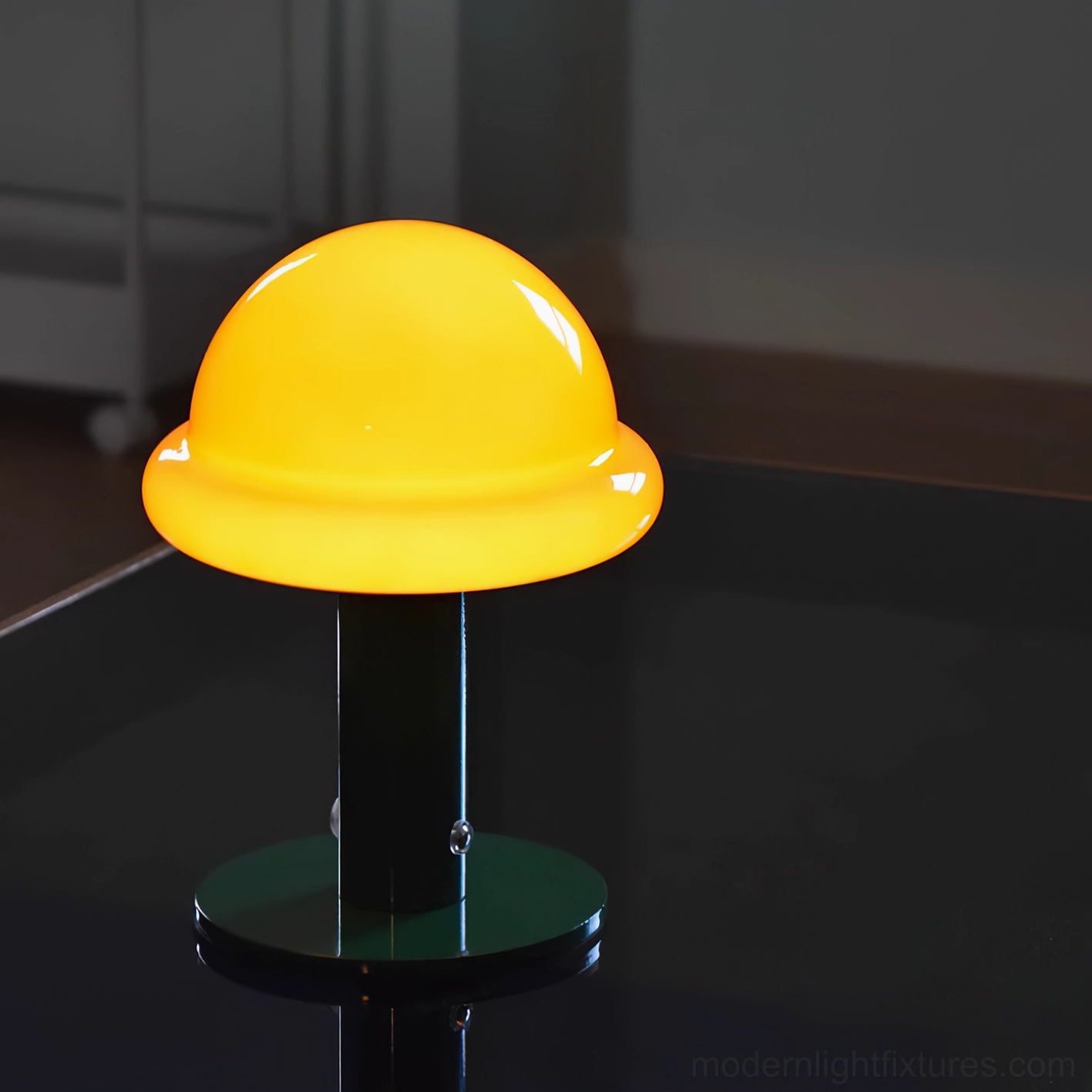 Yellow bright glossy mushroom table lamp with dark green metal pole and base on dark tabletop
