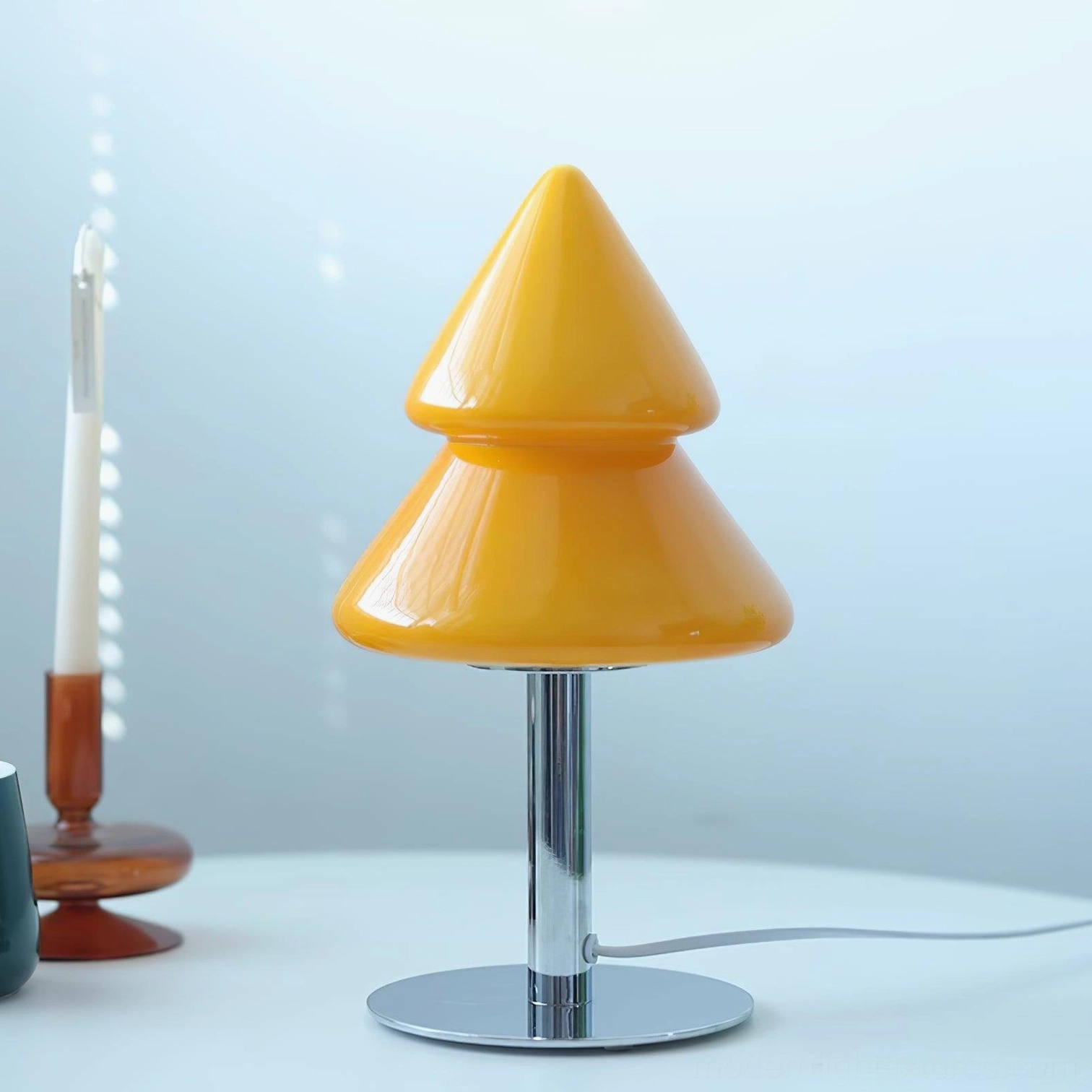 Yellow and chrome base Christmas tree lamp in polished metal minimalist setting