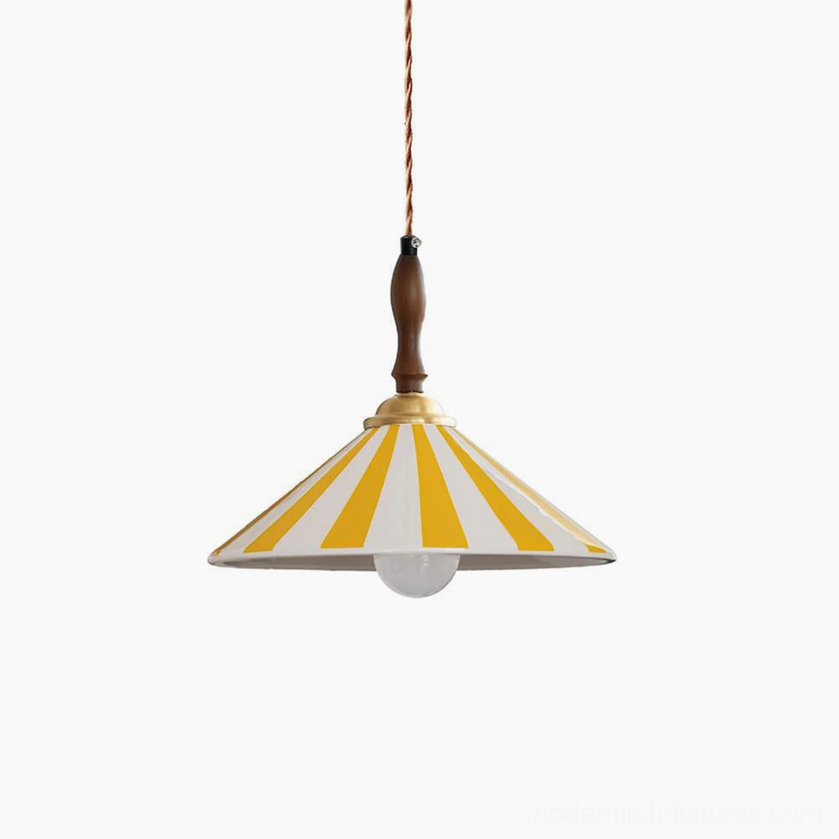 Yellow and white striped hand-painted ceramic pendant light with vintage carnival design and brass accents on studio white background