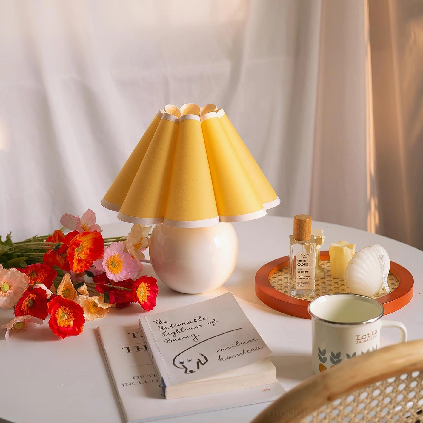 Sunburst pleated table lamp with white base and yellow shade creating warm ambient lighting in home interior with floral décor