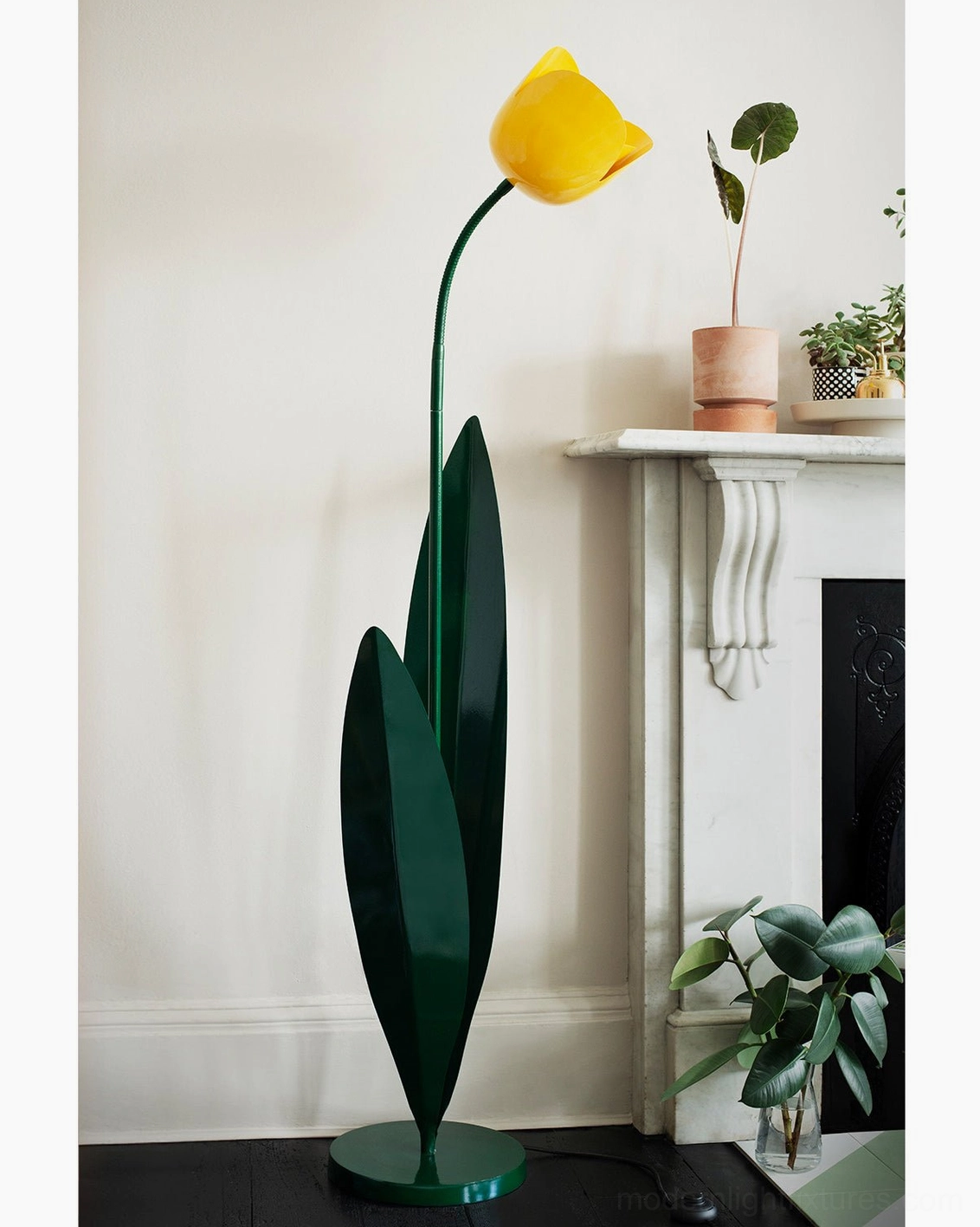 Yellow tulip floor lamp in European fireplace living room with green plants and warm decor – botanical floor light in transitional interior