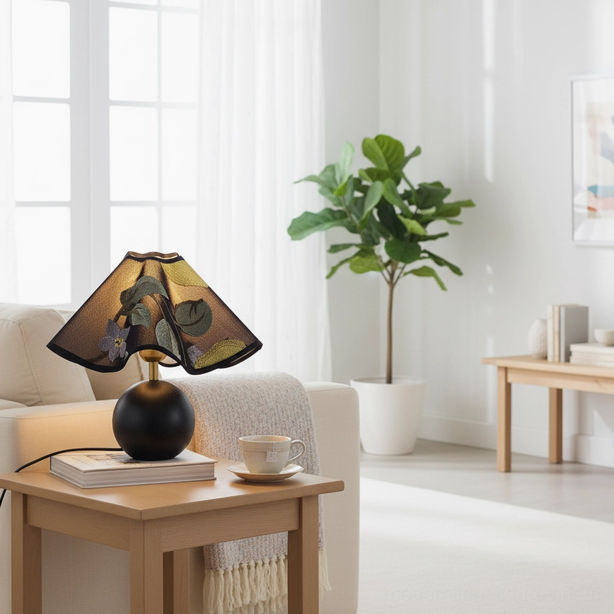 Zerina table lamp with black spherical base in modern living room on side table with coffee set