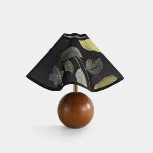 Zerina embroidered fabric table lamp with floral motifs and solid wood spherical base, frontal flat lay studio view
