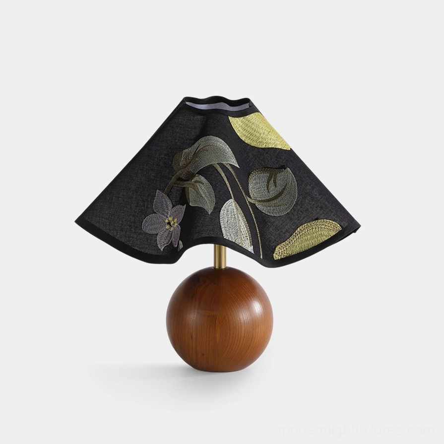 Zerina embroidered fabric table lamp with floral motifs and solid wood spherical base, frontal flat lay studio view