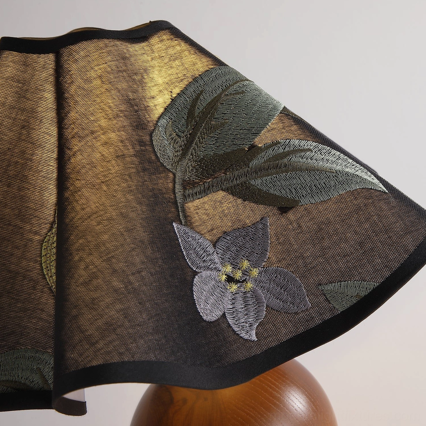 Zerina table lamp artistic view emphasizing craftsmanship and embroidered shade embellishment
