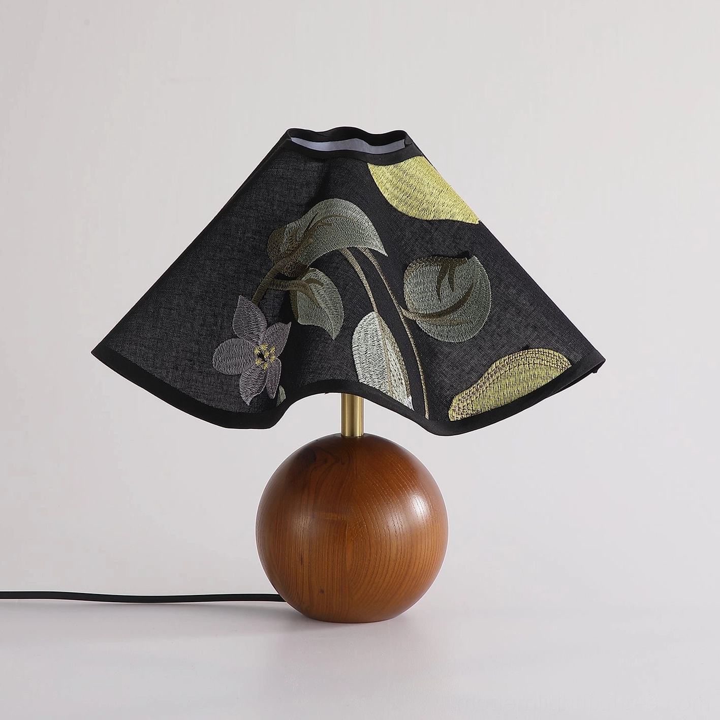 Zerina table lamp frontal three-quarter view showing brass connector and detailed floral embroidery