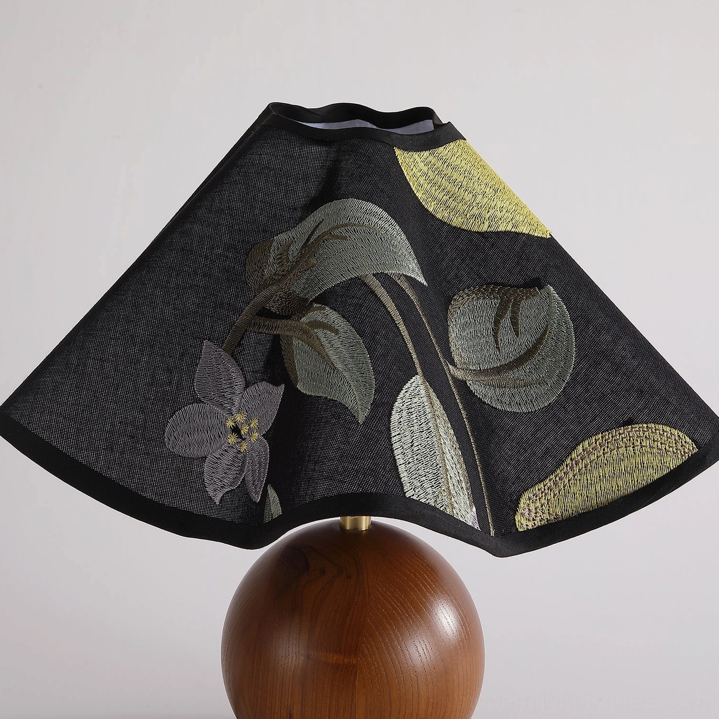 Zerina table lamp illuminated showing light diffusion through embroidered fabric shade