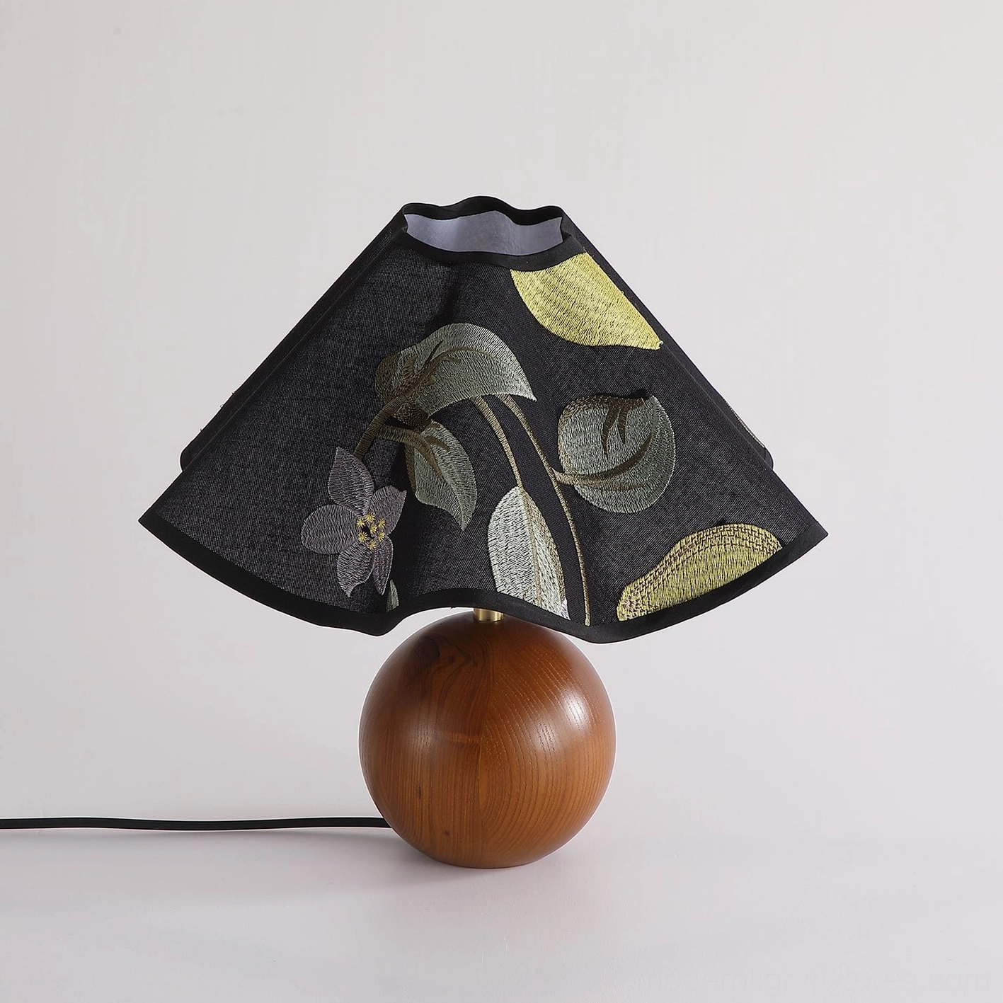 Zerina table lamp right three-quarter side view showing walnut wood base and power cord