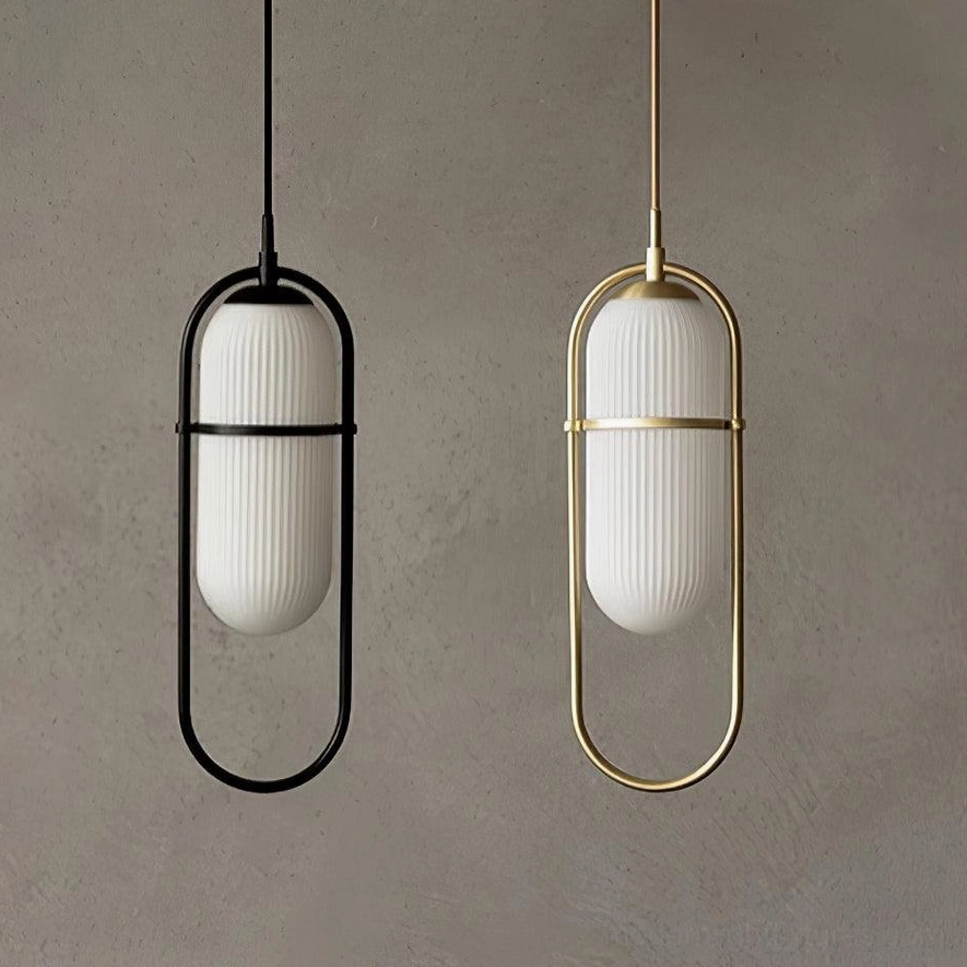 Matching pair of Zesta pendant lights in black and brass gold finishes with identical ribbed white glass shades