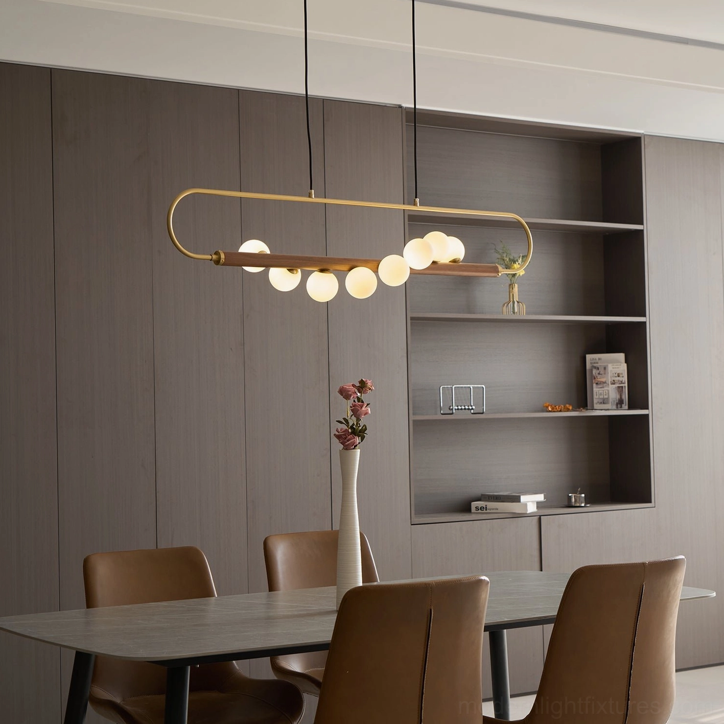 Zeta Linear Chandelier installed in elegant dining room creating architectural focal point above table with warm ambient lighting