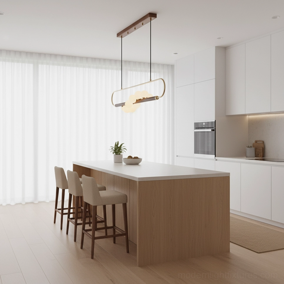 Zeta Linear Pendant installed above modern white kitchen island with minimalist design and brass metal hardware glowing warm