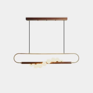 Modern Zeta Linear Chandelier - Front view with walnut bar, brass fittings, and frosted white glass globes on white studio background