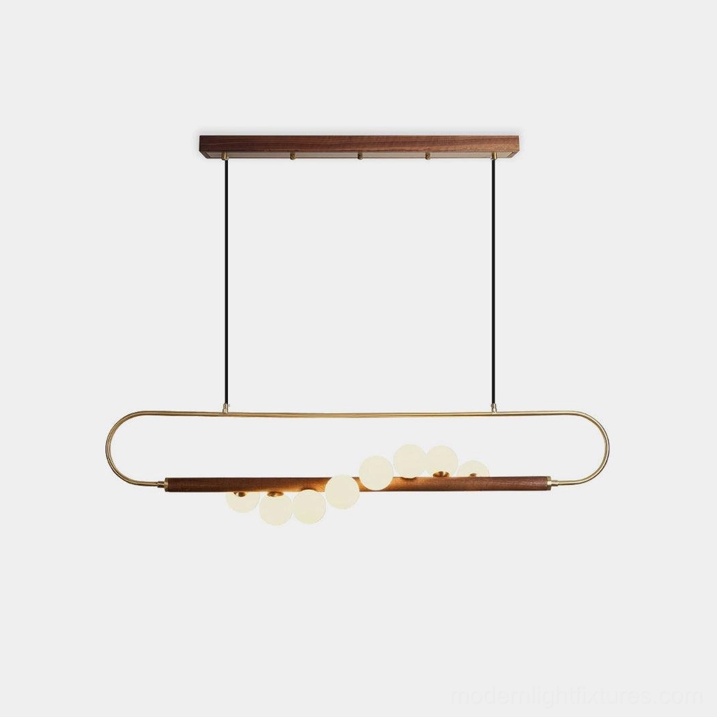Modern Zeta Linear Chandelier - Front view with walnut bar, brass fittings, and frosted white glass globes on white studio background