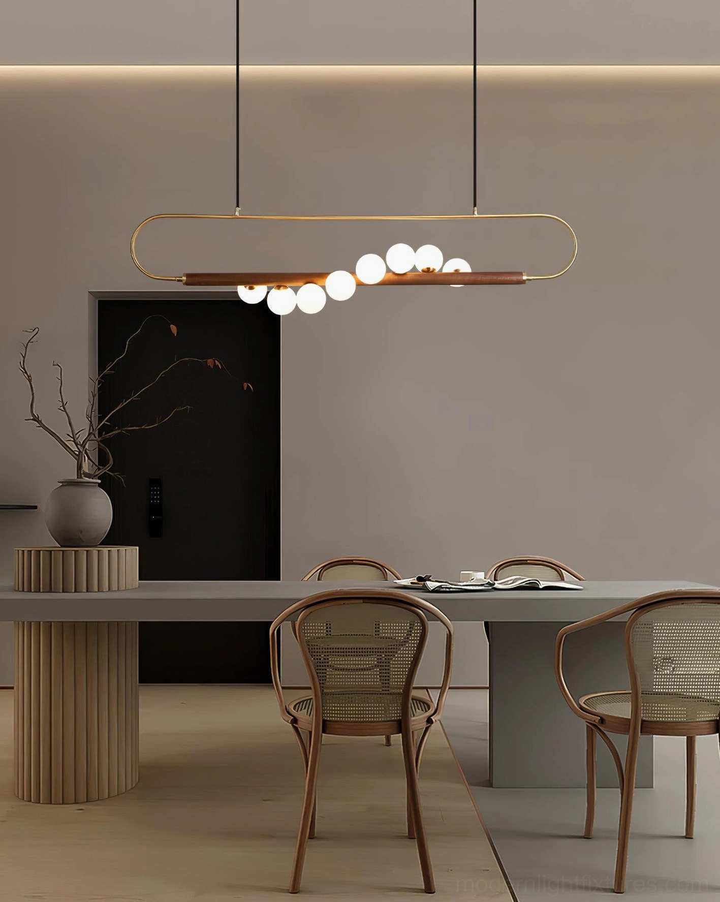 Zeta Linear Pendant Lamp detailed view of five frosted white glass globes suspended from antique brass fittings on walnut bar