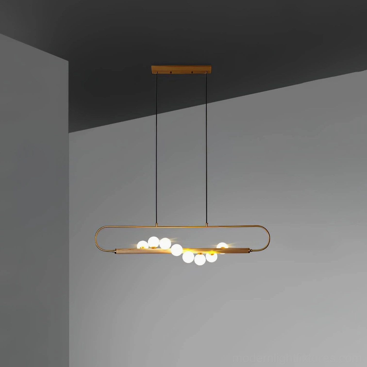 Zeta Linear Pendant close-up of walnut wood grain and brass antique finish showing material aging and natural patina